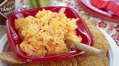 a red plate topped with crackers and cheese