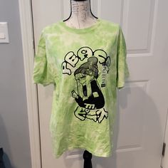 Nwt. No Rips, Tears, Or Stains. Size Medium Casual Crew Neck Shirt With Graffiti Print, Green Funny Print Top For Streetwear, Green Streetwear Top With Funny Print, Casual Tan Shirt With Graphic Print, Casual Tan T-shirt With Screen Print, Casual Tan T-shirt With Graphic Print, Casual Green T-shirt With Front Print, Green Cotton Tops With Graffiti Print, Green Cotton Top With Graffiti Print