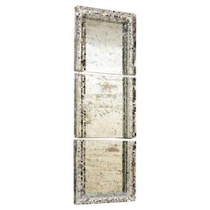 three mirrored mirrors on a white wall with silver trimmings and an ornate design