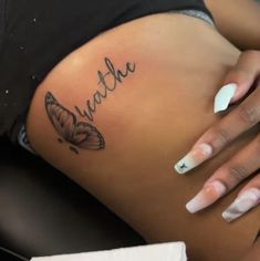 a close up of a woman's stomach with butterflies on her belly and the word faith written in cursive writing