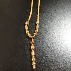 This 15 1/2" Long Necklace Has Golden Colored Seed Beads And 2mm Round Gold Findings. There S A Center Drop That Makes It The Focal Point Of The Necklace. It Has A Gold Tone Twist Closure. This Necklace Has Golden Colored Seed Beads And Rounded Square Gold-Tone Beads That Measure 3.93mm. There Are A Few 4mm Round Accent Beads, 3.93mm Round Roundel Beads, And Some Tiny 2.42mm Round Accent Beads Between The Seed Beads. This Is A Handmade Beaded Necklace. I Have Some Necklaces, Bracelets, And Earri Gold Dangle Jewelry With Spacer Beads, Adjustable Gold Necklace With Polished Beads, Gold Dangle Beaded Chain Necklace, Dangle Gold Beaded Necklaces For Jewelry Making, Adjustable Gold Beaded Necklaces With Dangling Beads, Gold Dangle Necklace With Polished Beads, Dangle Beaded Necklaces With Gold Beads For Jewelry Making, Adjustable Gold Necklace With Dangling Beads, Adjustable Gold Necklaces With Dangling Beads