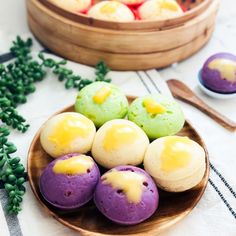 there are some colorful desserts in the bowl on the table next to each other