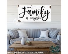 a family is everything sign hanging on the wall above a couch in a living room