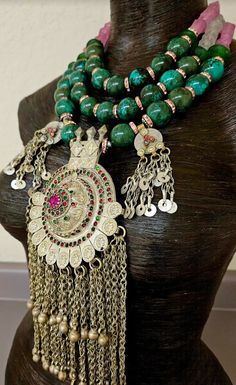 Huge 20 mm luxury turquoise round beads are each separated by pink rhinestone rondelles in this big, bold, heavy and dramatic showstopper tribal - ethnic beaded chest piece. The back of the necklace is finished with two shades of frosted pink glass beads and silver tone tribal spacers. The focal point is a big vintage Waziri Architectural Dome Pendant which measures approximately 9.5" x 4.5". The pink and green inlaid glass is intact, as are all the chain dangles. Two smaller charm dangles flank Bohemian Gemstone Beads For Wedding, Beaded Jewelry For Rituals And Festivals, Bohemian Beaded Necklaces With Silver Beads, Bohemian Wedding Beads, Turquoise Silver Beads For Festivals, Traditional Handmade Turquoise Beads, Bohemian Colorful Round Beads, Gems, And Cabochons, Colorful Bohemian Beads, Gems, And Cabochons, Traditional Green Beaded Necklace For Festival