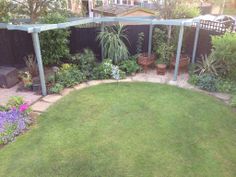 a backyard with lots of green grass and flowers