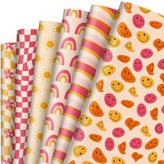 four different patterns with smiley faces on them, one in pink and the other in yellow