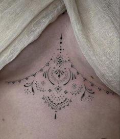 a woman's chest with an intricate design on it