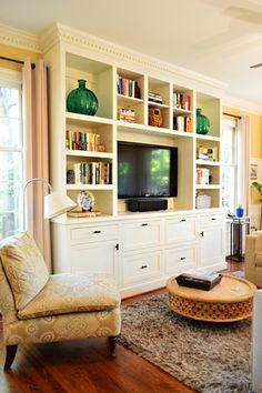 a living room filled with furniture and a flat screen tv