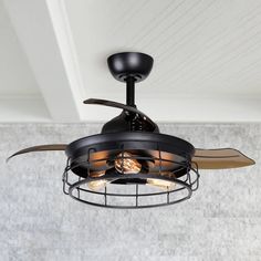 a black ceiling fan with two light bulbs and a wire cage around it's blades