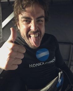 a man with his tongue out giving the thumbs up