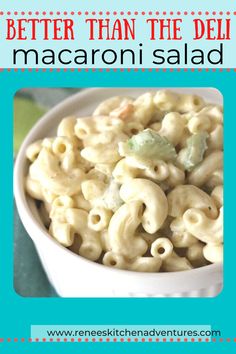 a white bowl filled with macaroni salad on top of a green tablecloth