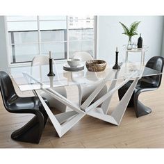 a glass table with black chairs around it