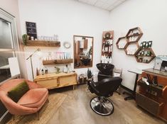 a hair salon with chairs, mirrors and other items on the wall in front of it