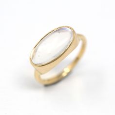 Stunning modern 14k yellow gold setting featuring a genuine vintage moonstone ring! This unique ring features a magical oval cabochon cut 3.22 carat moonstone, that is securely bezel set. This beautiful piece was crafted from a modern setting, and is set with a vintage gemstone. The illuminating gemstone displays unique natural inclusions, and the moonstone gives off glowing adularescense. An incredible genuine gemstone ring, that features a unique optical phenomenon! *Sale - price reduced from $1850 USD to $1725 USD.  ERA - Vintage gemstone, modern setting METAL / MATERIAL - 14k yellow gold, genuine vintage moonstone (approx. 3.22 CT) MARKINGS / HISTORY - Inside of band is marked "14k"  CONDITION - Good condition. (vintage gemstone added to modern setting) Yellow gold metal has been profe Optical Phenomena, Logo Gifts, Yellow Gold Setting, Unique Ring, Moonstone Ring, Gold Set, Oval Cabochon, Gold Style, Unique Rings