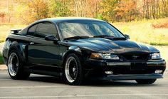 a black sports car parked in a parking lot