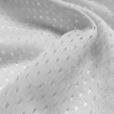 white fabric with small dots on it, as well as some other things in black and white