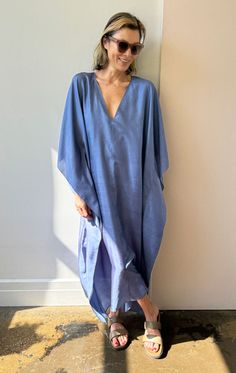 Our v neck sari caftan in a gorgeous blue handwoven silk A chic, easy oversized style Model is size 2/4 and 5'9 As this is a handmade product we recommend dryclean for silk Color: Blue — Width 45" flat across Length 50" — Handwoven Silk — One size fits all - (fits up to size 16) Chic Silk V-neck Kaftan, Blue Silk V-neck Kaftan, Spring Linen V-neck Kaftan, Spring Silk V-neck Kaftan, Casual V-neck Relaxed Fit Kaftan, Casual Linen V-neck Kaftan, Blue V-neck Kaftan For Beach Cover-up, Relaxed Fit V-neck Maxi Dress Unlined, Relaxed Fit V-neck Unlined Maxi Dress