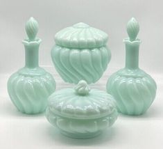 three green vases sitting next to each other