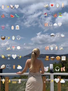 a woman standing on top of a balcony next to a railing with lots of bubbles floating in the air