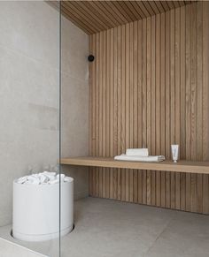 a bathroom with wooden walls and white fixtures