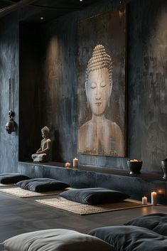 a large buddha statue sitting on top of a wooden table in front of a painting