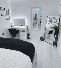 a white bedroom with black and white decor