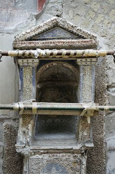 an old stone building with a small window