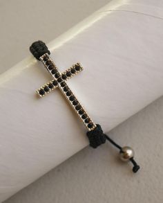 Black Braided Bracelet with Black Rhinestones Cross Will fit wrists from 6" to 9" MATERIAL: Nylon cord CROSS: Rhinestones. Measures 1-1/2" to 7/8" Come Visit Us at Our New Store! Please feel free to email me with questions that you may have.  Also please check my other listings. I am always available to answer your questions promptly Rosary Bracelet, Rhinestone Cross, Rainbow Glass, Braided Bracelet, Miraculous Medal, Black Braids, Black Rhinestone, Braided Bracelets, Charm Bracelets