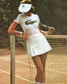 the tennis player is posing with her racket