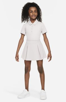 This breathable, kid-sized golf skirt will keep them comfortable on the green with a pleat-flared silhouette, stretchy inner shorts and helpful hidden pockets. 86% polyester, 14% spandex Machine wash, line dry Imported Nordstrom x Nike: A curated lifestyle destination where fashion is the ultimate sport Girls Golf Clothes, Tennis Skirt For Kids, Sporty 4-way Stretch Tennis Skort, Sporty 4-way Stretch Golf Shorts, Golf Skort With Stretch And Built-in Shorts, Golf Skirts, Sports Skirts, Nike Kids, Dri Fit