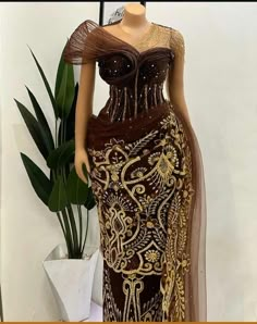 a mannequin wearing a brown and gold dress