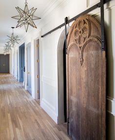 a large wooden door in the middle of a hallway