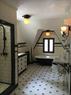 an attic bathroom with black and white tile