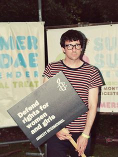 a man is holding a sign in front of him