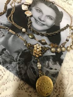 This is s handcrafted vintage assemblage multistrand necklace.  It has.  Piece of vintage hardware to which I added a faux pearl accent.  Beneath this hangs a goldtone vintage locket/pocket watch.  The sides contain an array of vintage fax pearls, mother of pearl, beads and goldtone chains in a mosaic style.  It is very unique and makes a statement!  No returns.  Ship to continental US only. Bohemian Gold Locket Necklace With Vintage Charm, Vintage Gold Jewelry With Pearl Charm, Vintage Double Strand Gold Jewelry, Vintage Gold Double Strand Necklace, Vintage Bronze Multi-strand Jewelry, Vintage Multi-strand Gold Jewelry, Unique Vintage Charm Necklaces, Vintage Gold Multi-strand Jewelry, Vintage Gold Multi-strand Necklace