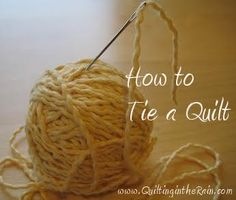 a ball of yarn sitting on top of a wooden table next to a knitting needle