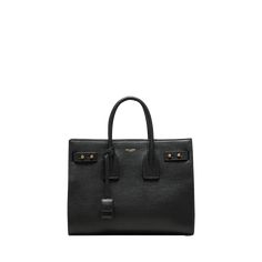 Saint Laurent "Sac De Jour" top handle bag in grained leather  Rolled top handles with removable tag, 3.7" drop Detachable shoulder strap, 18.8"L Open top with side adjustable straps  Center zip compartment divides interior  Golden hardware  Feet protect bottom of bag  Approx. 10"H x 12.5"W x 6.1"D Made in Italy Open Top, Handle Bag, Leather Top, Top Handle, Saint Laurent, Adjustable Straps, Top Handle Bag, Tops Designs, Shoulder Strap