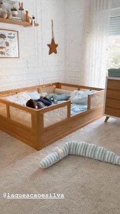 a child's bed in the middle of a room with a worm crawling on the floor