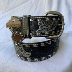 "You are looking at a genuine leather belt from TEX TAN. Belt measures 34\" long with 26\"5 from the first perforation and 30\"5 at it's last perforation from buckle and 1\"4 wide. The condition of this belt is very good and is made of black leather with  silver tone details and hardware. 100% genuine TEX TAN made in USA size 30.  -----------------------------------------I SHIP WORLDWIDE------------------------------------------------- I want to stress that item is vintage which means it's not n Hand Tooled Silver Leather Belt Buckles, Black Hand Tooled Leather Belt Buckles, Black Leather Hand Tooled Belt Buckles, Black Hand Tooled Western Belt Buckles, Black Leather Belt Buckle With Antique Design, Black Western Style Embroidered Belt, Black Belt With Antique Buckle For Rodeo, Vintage Silver Engraved Belt, Western Silver Embroidered Belt