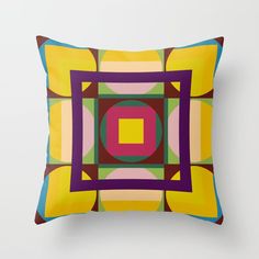 a square pillow with an abstract design on the front and sides, in multicolored squares