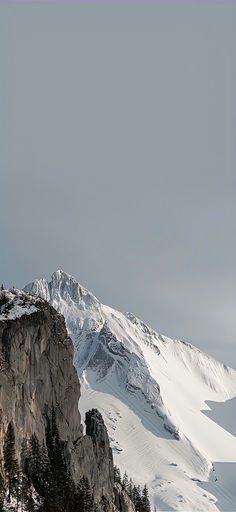 a person standing on top of a snow covered mountain