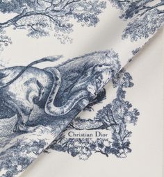 Modern yet timeless, The Toile de Jouy Sauvage blanket highlights the hallmark House motif. Crafted in white and navy blue wool, the style is embellished with hand-sewn edging and is further enhanced by the Christian Dior signature. The blanket can be draped over the shoulders or elegantly placed over living room furniture.. Dior Garden, Denim Swimsuit, Blanket Poncho, Icon Shoes, Blue Toile, Brand Aesthetic, Candle Branding, Christian Dior Couture, Winter Print