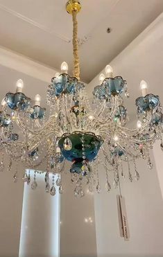 a chandelier hanging from the ceiling in a room