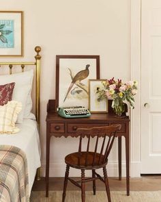 a bedroom with a bed, desk and pictures on the wall next to each other