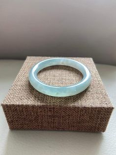 "🌈 Jade Bangle 53.9mm (2.12\"), Round Shape, Light Green 🌷 Untreated Natural Jadeite/ Grade A Jade 🌷 Certified : Yes 🌷 Jade from Myanmar/ Burma 🌷 Shape : Round 🌷 Inner diameter : 53.9mm / 2.12\" 🌷 Width & Thickness : 9.6 x 9mm 🌷 Color : Light Green 🌷 Free standard shipping from Hong Kong with tracking included 🌷 Take approximately 7-21 days to arrive worldwide ❤️ In Chinese Culture: Young people wear jade pendant will have a prosperous life, attracts good luck and friendship Old pe Round Crystal Bracelet With Natural Stones, Round Jade Crystal Bracelet With Gemstone, Jade Gemstone Crystal Bracelet, Spiritual Round Bangle With Natural Stones, Handmade Round Jade Bangle, Adjustable Green Jade Bangle, Blue Hand-strung Jade Jewelry, Hand-strung Round Jade Bracelets, Green Hand-strung Jade Bracelets