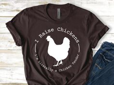 a brown t - shirt with the words raise chickens, and a white chicken on it