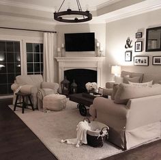 a living room filled with furniture and a fire place in the middle of a room