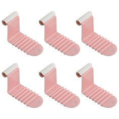 six pink plastic shoe clips with white tips