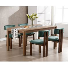 a dining table with four chairs and a placemat on the table in front of it