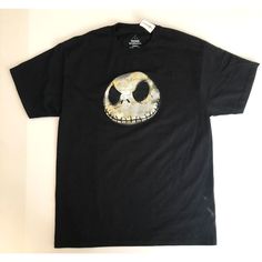 a black t - shirt with a skeleton face on it